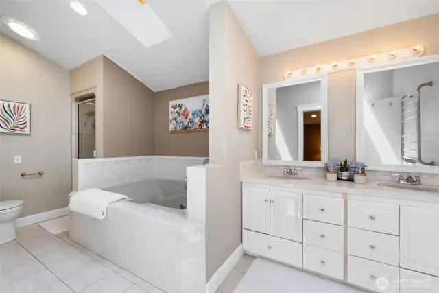 Now we enter the ensuite. Stone tile flooring, double vanity, separate shower and oversized jetted tub are features, but wait...there's more....