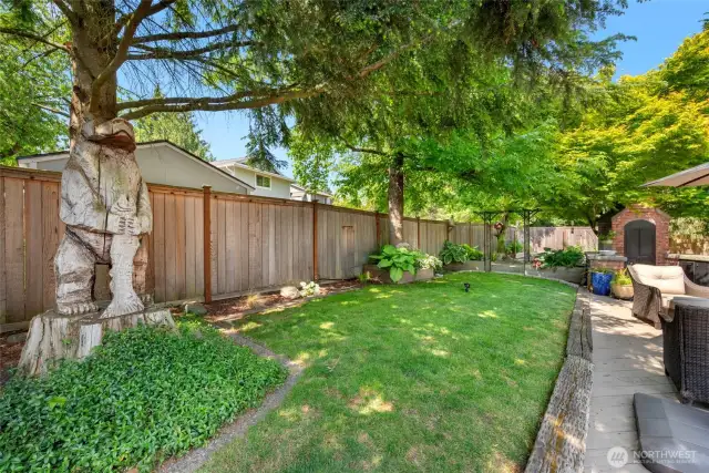Upper garden/yard space is awesome. Not only does it provide shade, it features Bear and fish carving. Bear and fish look over the hard and keep an eye on all the happenings. Notice the above ground sprinkler...it stays.