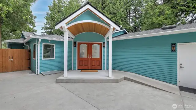 Covered entry.  To the side is a black metal gate that enclosed morning patio.