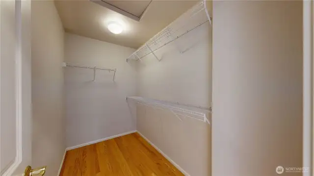 Spacious walk-in closet in the primary suite, complete with built-in shelving and hanging space to keep everything organized.