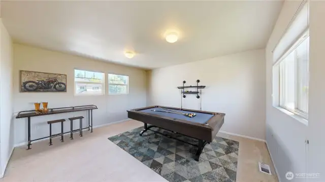 Bright and spacious bonus room offers endless possibilities—perfect as a game room, home theater, hobby space, or second living area with a large windows bring in plenty of natural light.