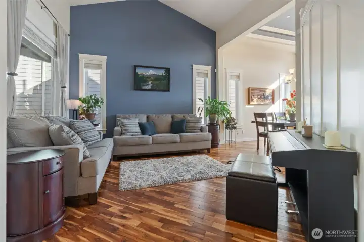 Enter into the living room that is open to the upstairs railing above.