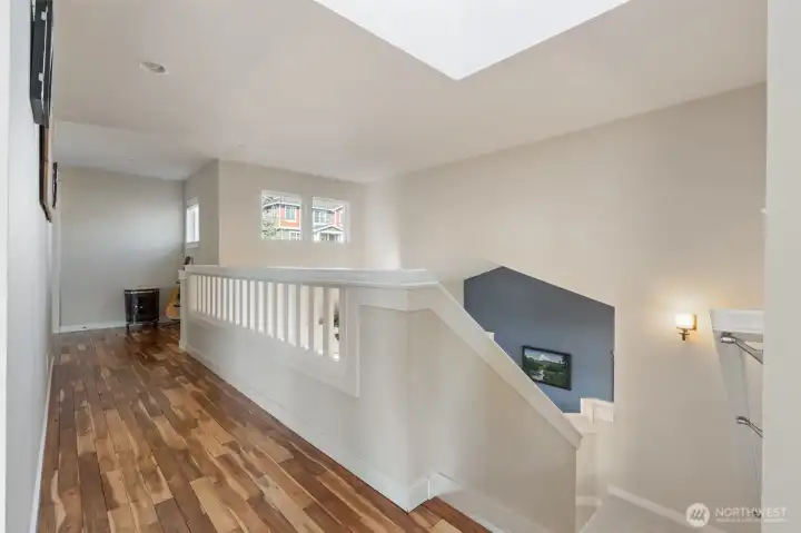 Beautiful open area on upper level with skylight above.