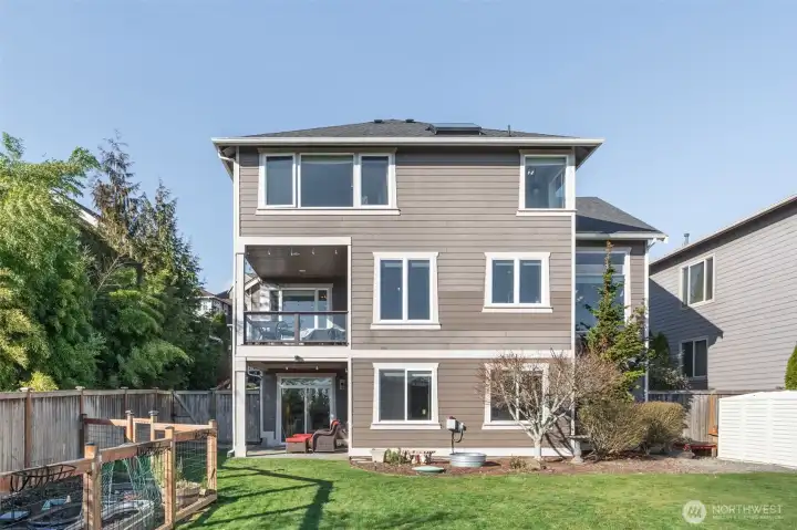 Back of home in large backyard, fully fenced with separate fully fenced garden.