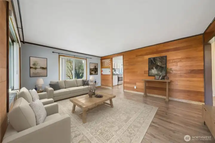 Enter to the living room with new flooring and windows to allow for natural light. (virtually staged)
