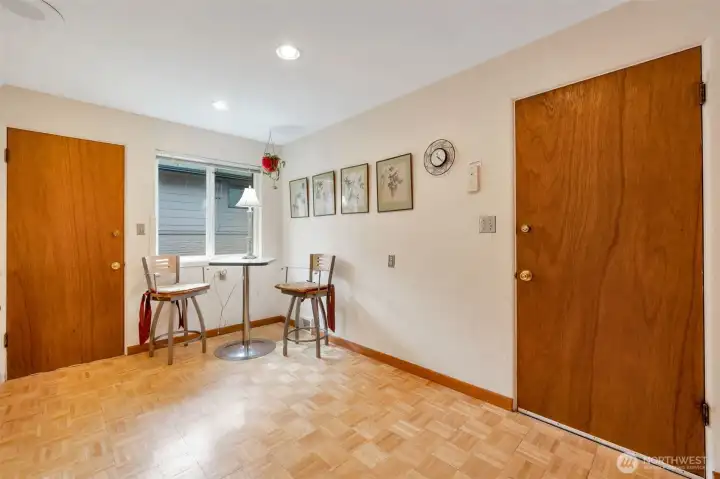 Kitchen eating space, door to left goes to outside deck, door to right goes to garage.