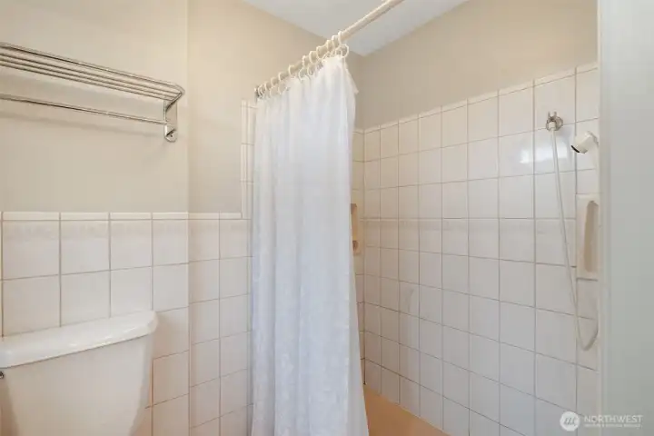 Wheel chair accessible shower main floor bathroom.