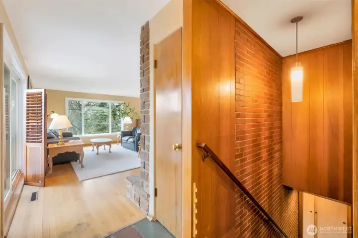 Sliding door to deck on left, stairs to lower level on right.