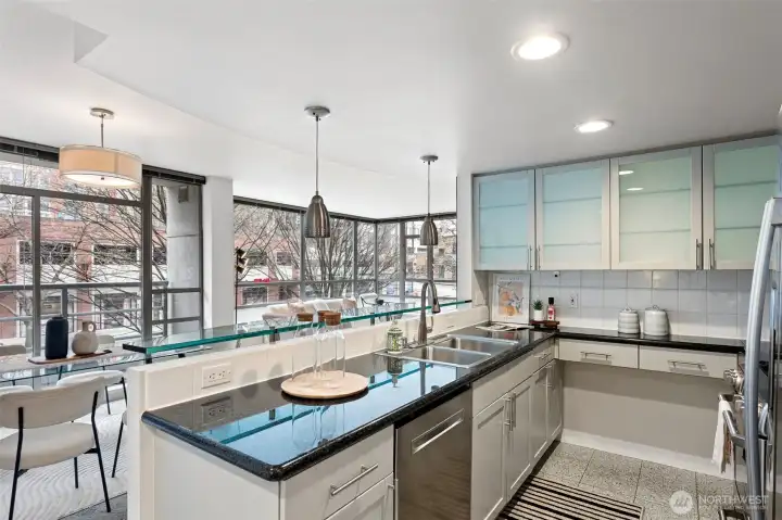 Granite countertops, breakfast bar & ample cabinetry.