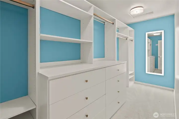 Spacious walk-in closet with generous shelving and organized storage