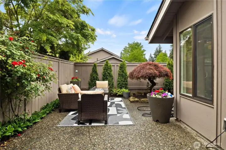 Inviting patio retreat with easy-care landscaping, bright seasonal color, and a stunning Japanese maple centerpiece