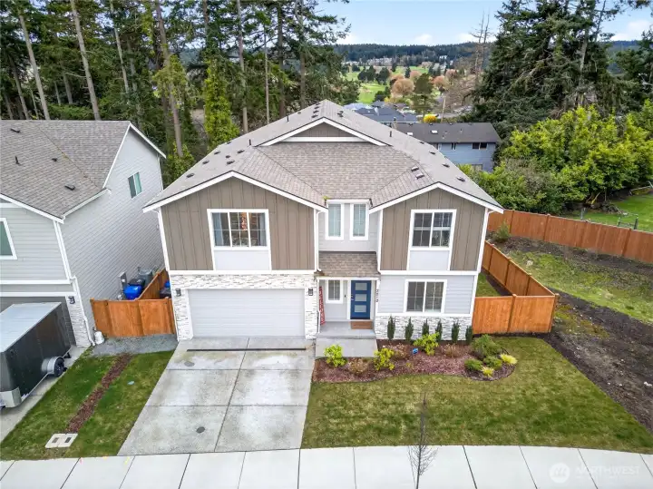 Beautifully maintained two-story home with modern curb appeal, stone accents, and a welcoming front entry, located in a quiet neighborhood with a fully fenced yard and attached two-car garage.