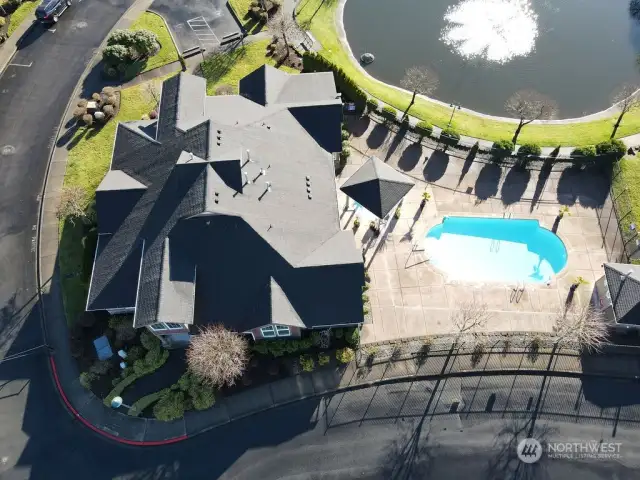 Aerial view of clubhouse, pool and pond.