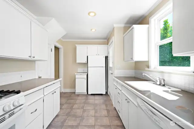 The galley-style kitchen offers lots of cabinets and countertops. The refrigerator is only 2 years old.