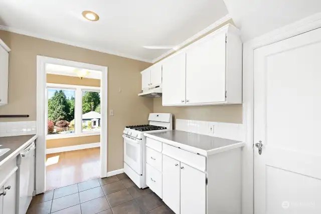 This kitchen photo shows the door to the basement on the right