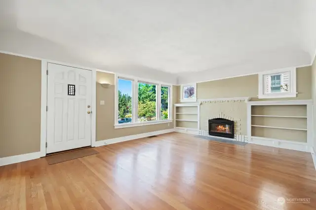The living room welcomes you in with the warmth of a fireplace and oak flooring. The living room lead-paned windows, built-ins and fireplace surround are original and the insert has been upgraded to gas.
