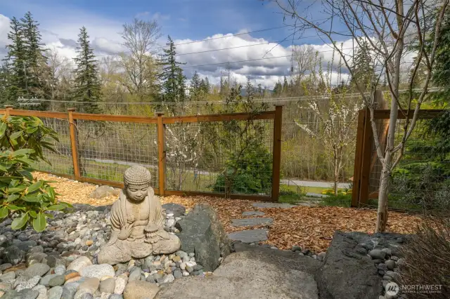 This gate leads to sitting areas and a private trail that meets up with the city trail you can see in the background