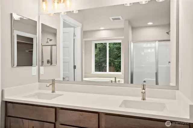 Primary bathroom with dual sink vanity and quartz counters.  Home under construction, photo for illustration only.