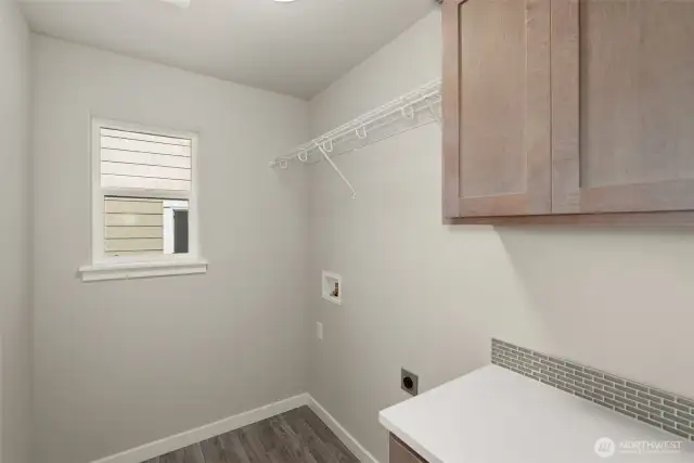 Laundry room with cabinets. Home under construction, photo for illustration only.