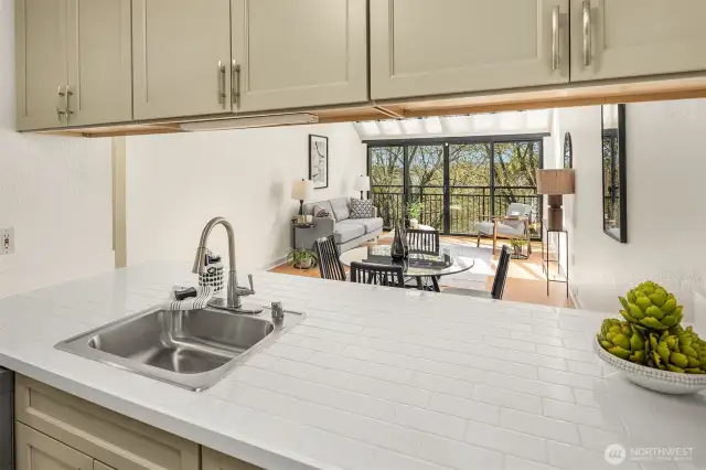 The kitchen seamlessly flows into the living space, offering a functional and cohesive layout perfect for entertaining.