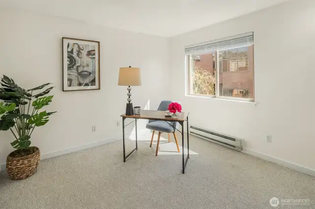 A versatile second bedroom, freshly painted and ready to serve as an expansive office or inviting guest space.
