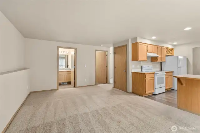 family room, looking towards half bath and utility room/garage