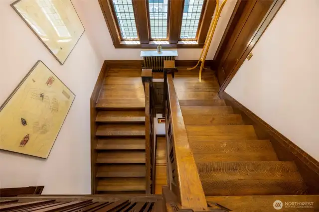 Sunlit staircase with elegant woodwork.