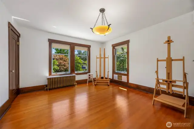 Versatile second-floor room with an original light fixture, perfect as a bedroom or creative space.