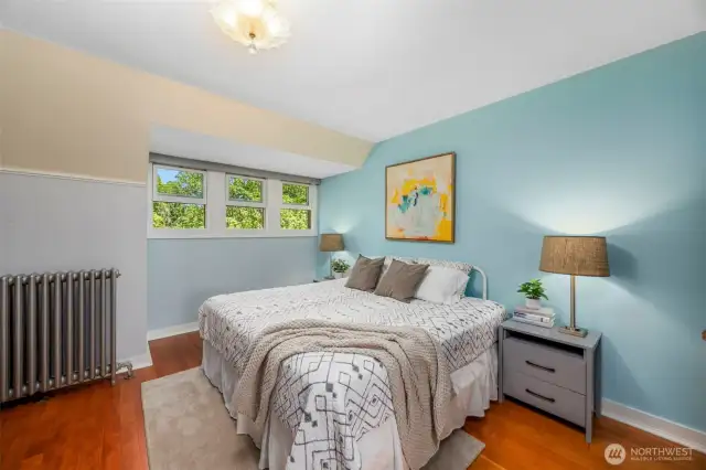Cozy upstairs bedroom with wood floors  — great for guests or kids.