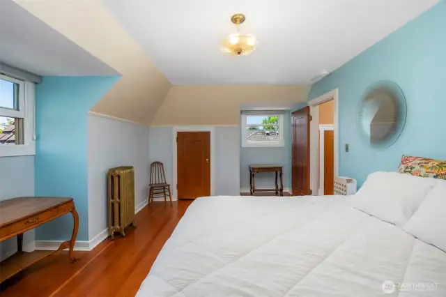 Another upstairs bedroom featuring ample natural light.