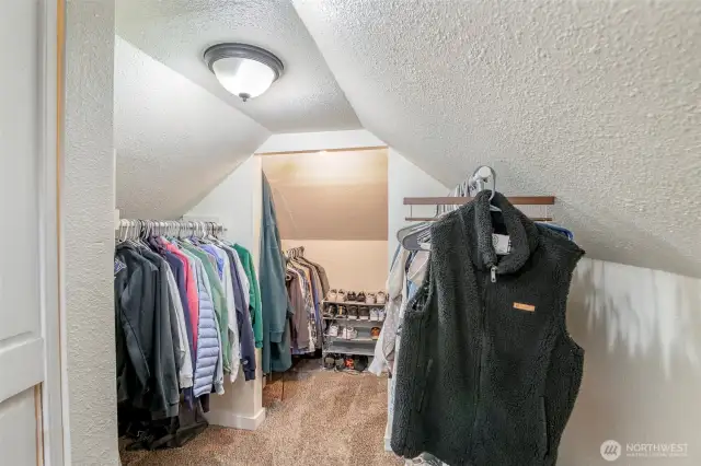 The large walk in closet is full of storage and ample space for clothes and shoes.