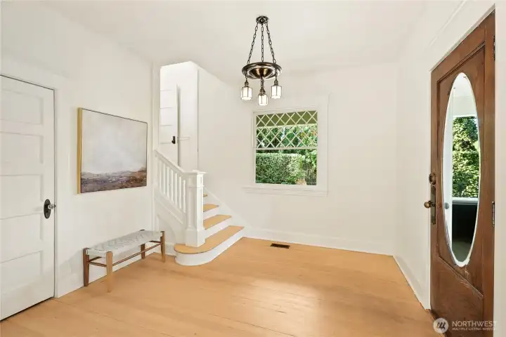 Beautiful entry | pass through staircase & original pocket doors to the living room.