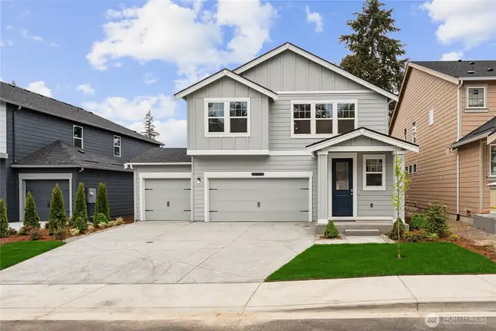 Picture is of actual home. Desirable grey tone exterior with a welcoming blue door.