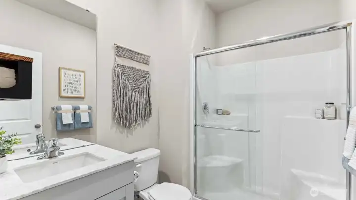 Bathroom downstairs features a walk-in shower. Pictures are for representational purposes only, colors and features may vary.