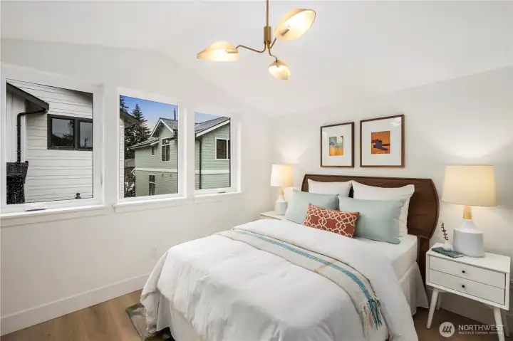 Guest room with vaulted ceiling and ample natural light