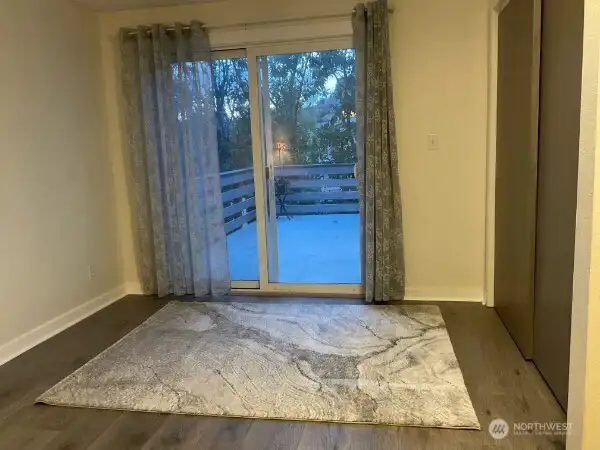 Primary Bedroom with slider door lead to deck that overlooks backyard.