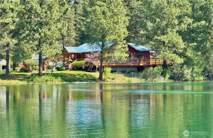 Expansive deck overlooking the peaceful waterfront setting.
