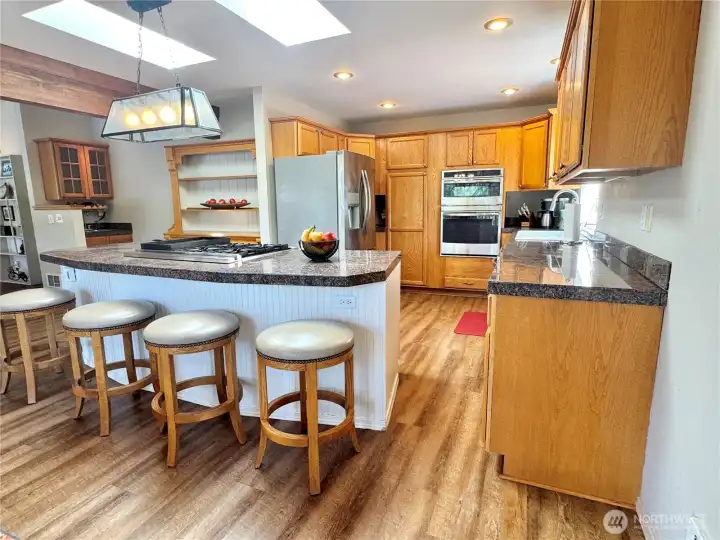 Skylights brighten the spacious kitchen beautifully. Oversized eating bar perfect for entertaining guests.