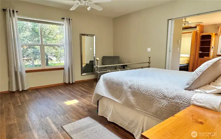 Spacious primary bedroom with view.