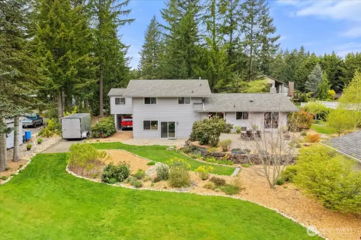 Beautifully landscaped 3/4 acre lot includes flowers, plums, and raspberries!