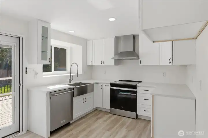 Refreshed kitchen with new cabinets, and quartz countertops, kitchen, new stove/oven.