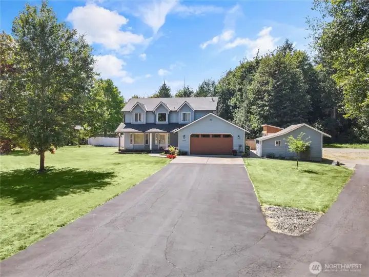 Double driveway and front yard.  House sits well off the private street with generous parking area off second driveway.