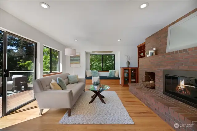 The spacious family room is perfect for  gatherings. Enjoy the warmth of the  wood-burning fireplace with brick mantel  that provides the perfect place to show off  your favorite possessions. Notice the built-in  bench seat, which is ideal for reading a book  and looking out the window to the natural  surroundings.
