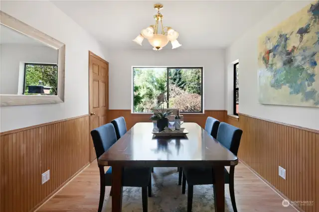 The formal dining room is right off the  kitchen for easy access when entertaining.  This is a great space for friends and family to  gather! To the left, you'll find a pantry for all  your hosting dinnerware, serveware and  linens.