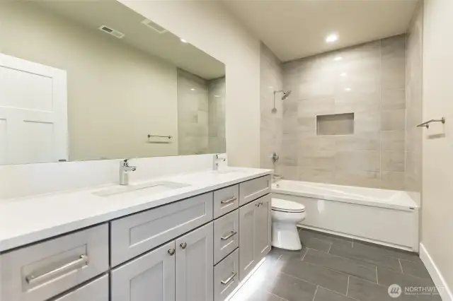 Guest bath with custom tile, double sink vanity