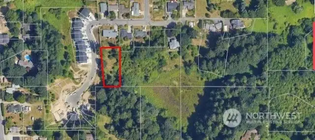 Aerial showing expanse of natural area abutting lot. All property lines approximate