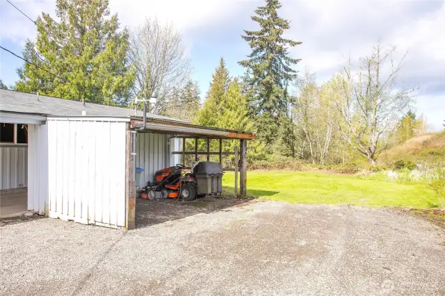 Even more covered storage attached to carport & extra parking