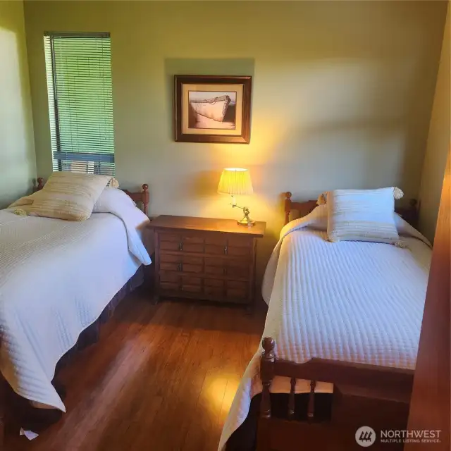 Possibly primary bedroom because it has a half bath adjacent.