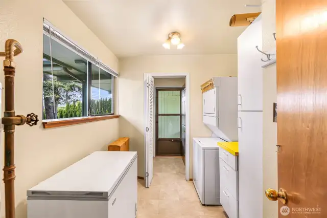 Utility room is off of the entry and another external door leads here through a "mudroom" with a shower to the carport.
