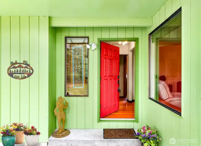 A very stylish door that is solid wood and has a schooner ship carving.